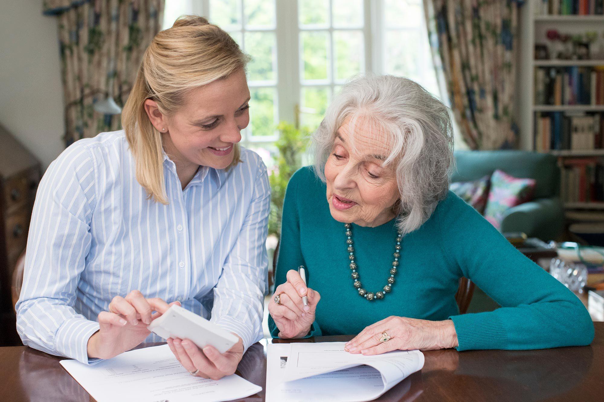 An elderly woman discussing financial power of attorney with her elder law attorney