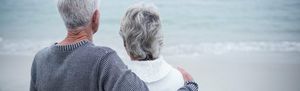 An elderly couple looking out into the ocean