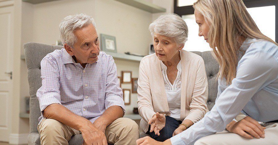 An elderly couple with their attorney discussing estate planning