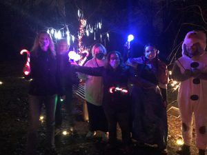 A group of people celebrating at the winter wonderland event at ELIJA Farm