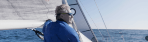A middle aged man on a sail boat