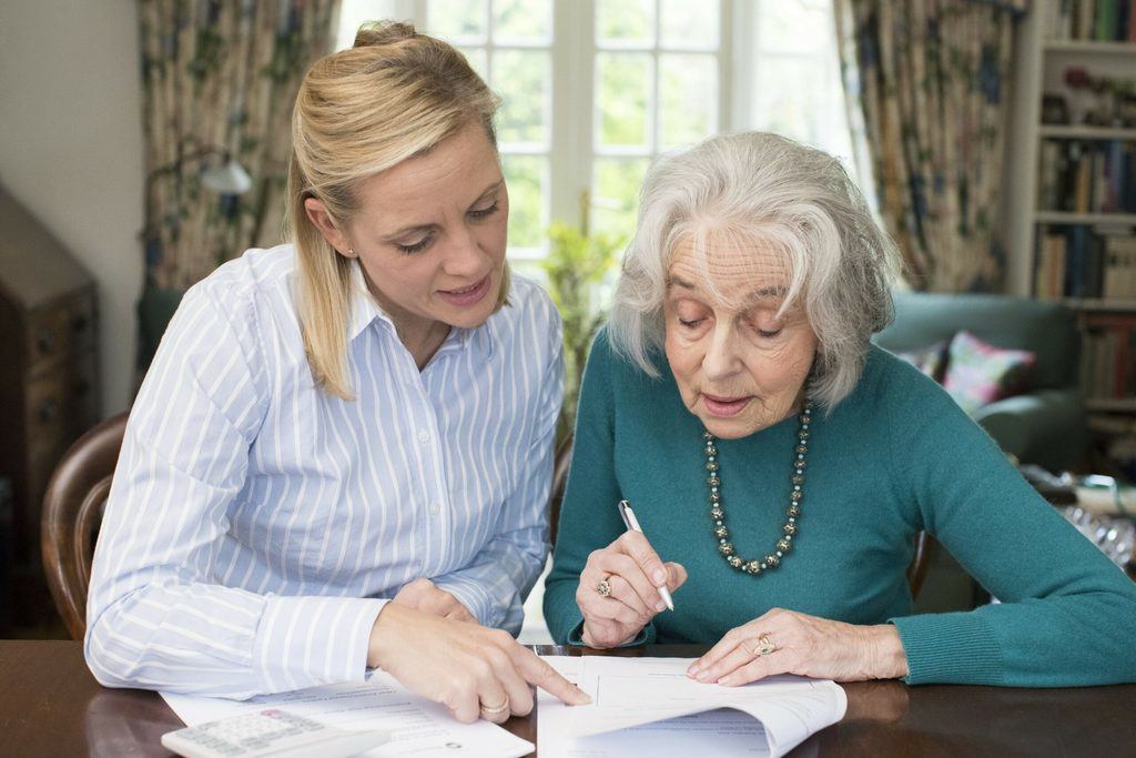 A mother and daughter filling out power of attorney paperwork