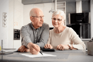 An elderly couple discussing their estate planning documents together