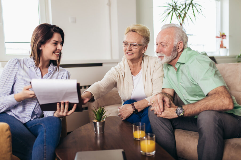 Positive aged couple consulting with an estate planning attorney