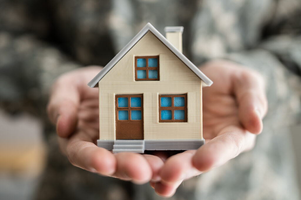 Military Army Man In Uniform Holding New House