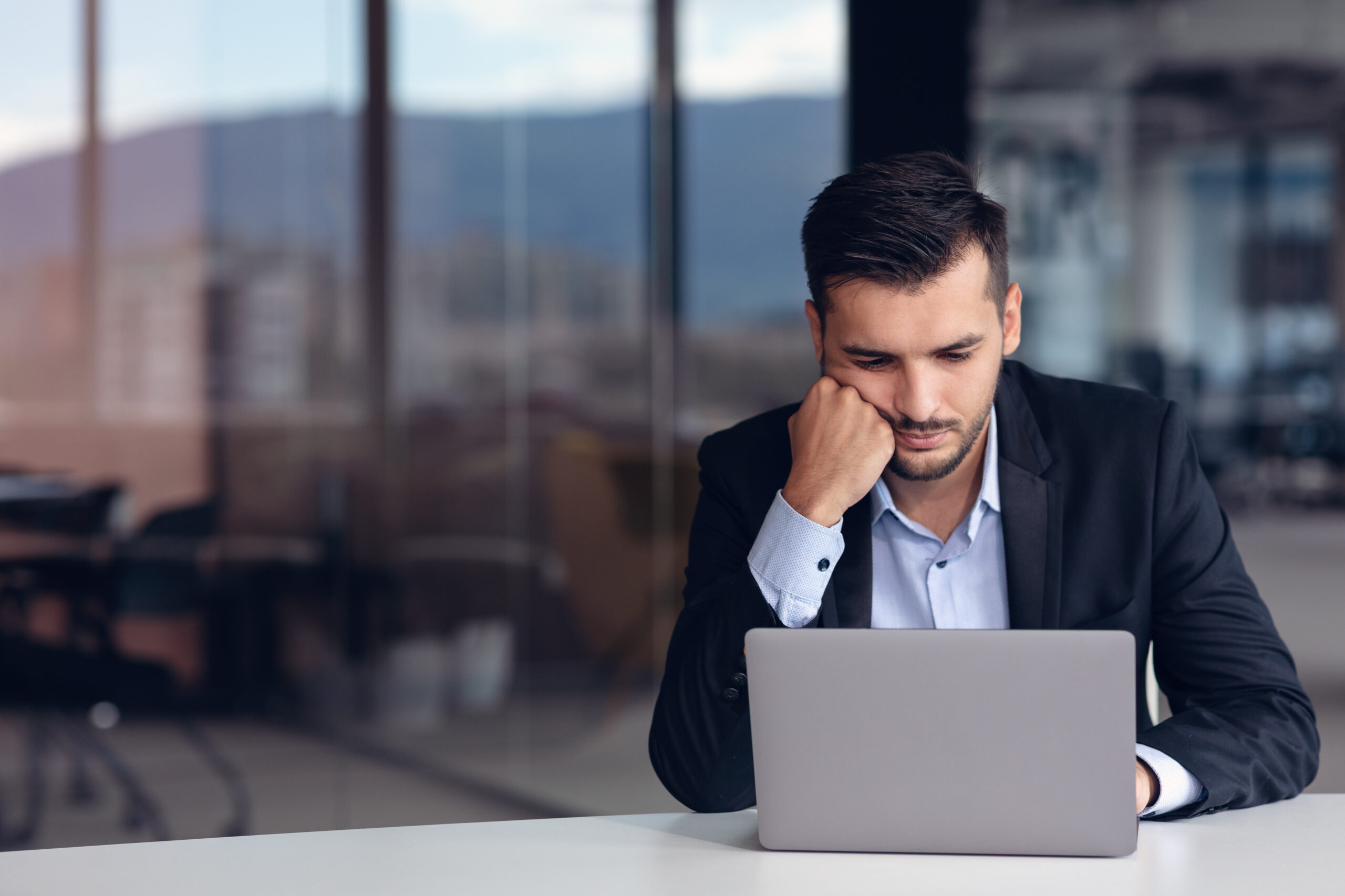 Portrait of worried young man at workplace